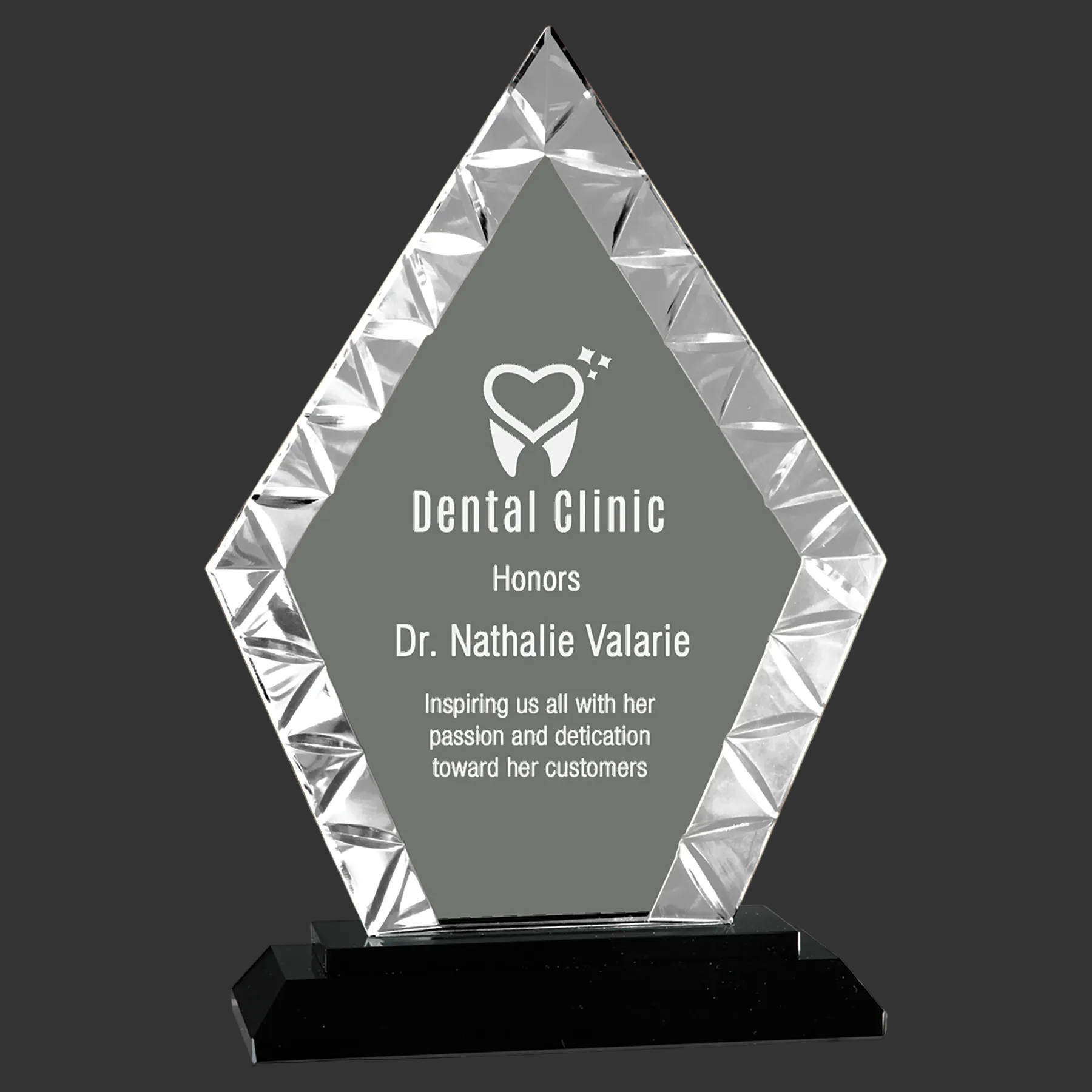 Crystal diamond-shaped award on a black base with a gray background