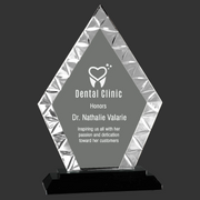 Crystal diamond-shaped award on a black base with a gray background
