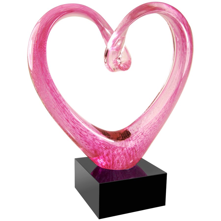 Pink heart-shaped glass sculpture on a black base against a white background