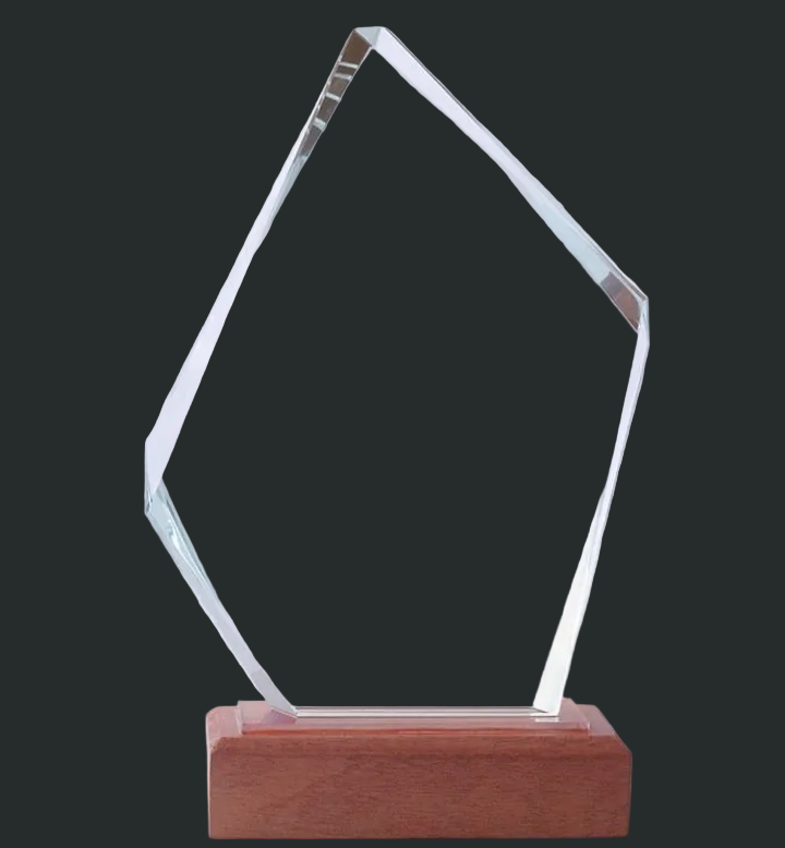 Clear glass award on a wooden base against a gray background
